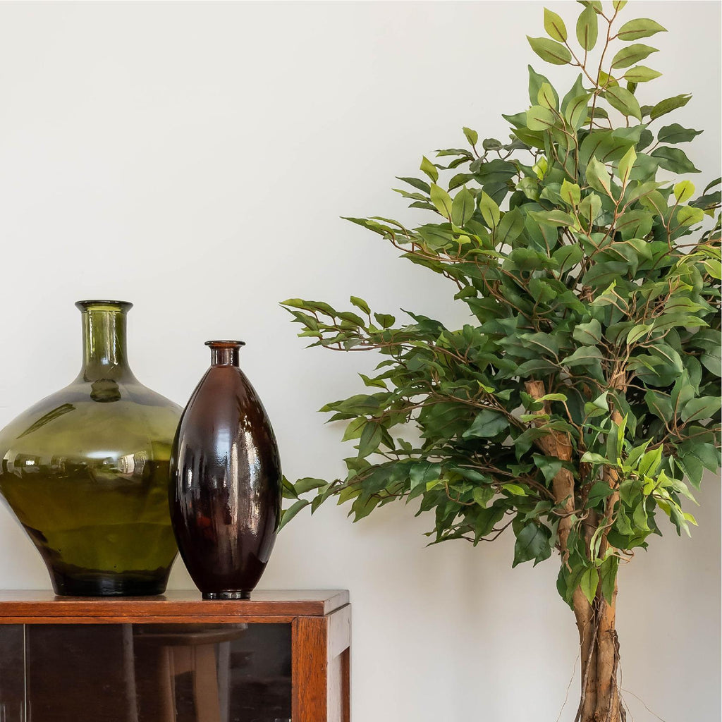 Artificial tree in a dining room with decorative vases