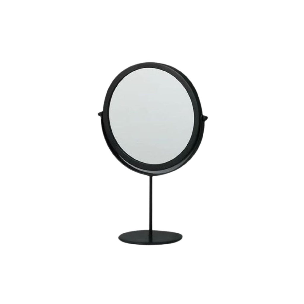 Round black mirror on pedestal