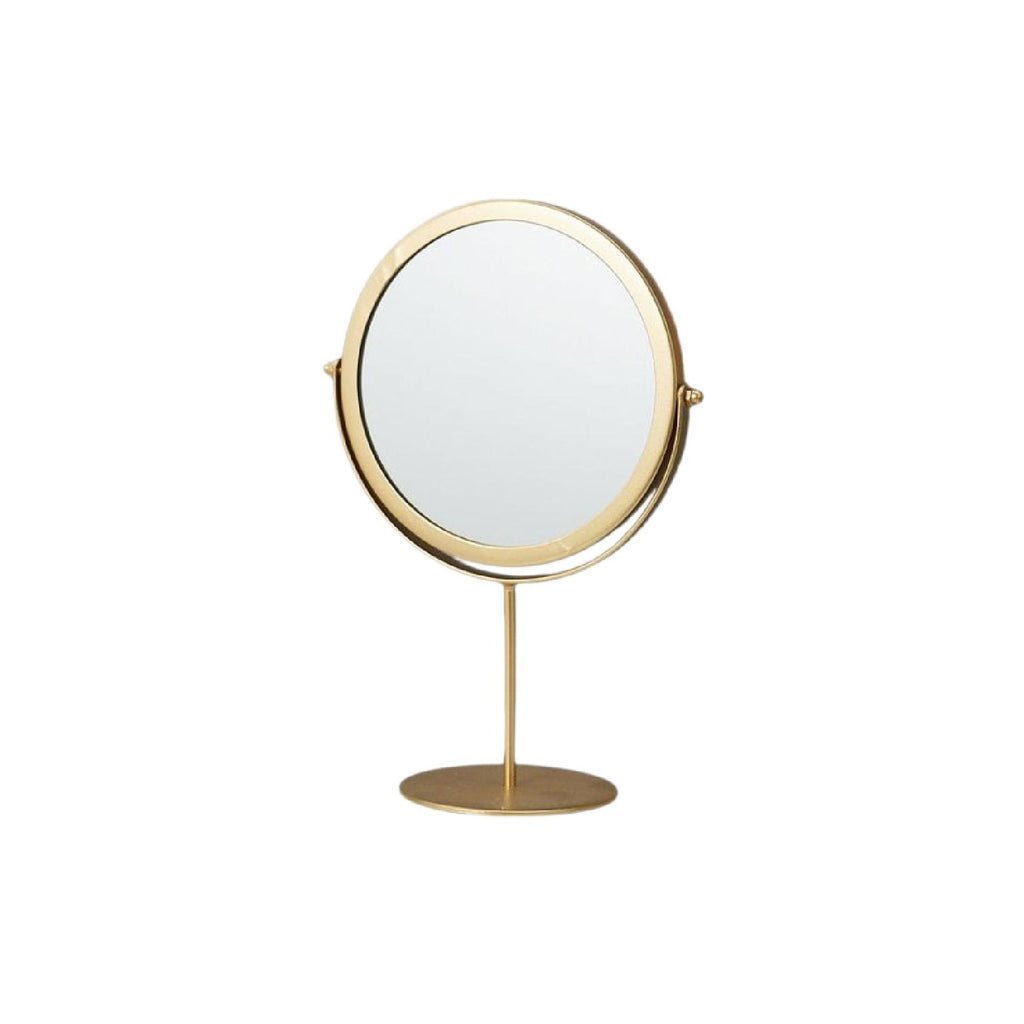 Round gold mirror on pedestal